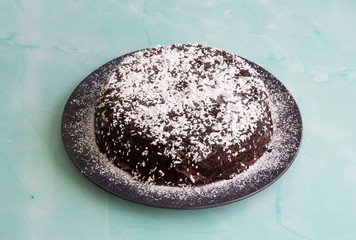 Pumpkin pie with chocolate coconut syrup and powdered sugar