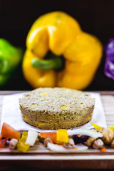 homemade vegan hamburger without meat, made from vegetables on rustic wooden background with colorful vegetables. Vegetarian life and vegetarian life concept.