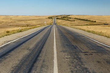 Fototapeta na wymiar empty asphalt road across the steppe, Kazakhstan, Khromtau District, Highway M32