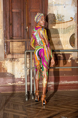Young African girl in colourful paint. Body painting art.