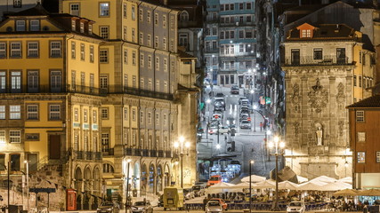 traditional quaint houses in the old, vintage and touristic ribeira district of Porto at night timelapse, Portugal