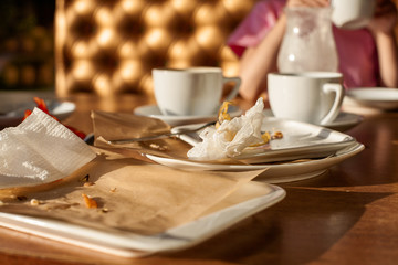 Empty dirty plate on table in cafe