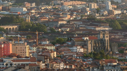 Fototapeta na wymiar Rooftops of Porto's old town on a warm spring day timelapse before sunset, Porto, Portugal