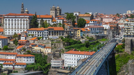 Beautiful view of the Douro River timelapse and the embankment of the historic centre of Porto city on the blue sky background in Portugal at summer time.