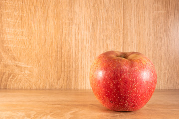 Apple on wooden table .