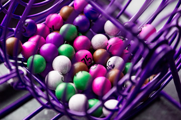 purple lottery game in close-up with different colored balls with numbers