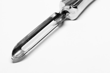 a potato peeler in black and white with a sharp tip