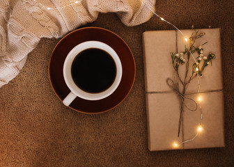 A cup of coffee and a book on a plaid. Sweet home. Good morning. Reading and home relaxation concept. Top view, flatlay