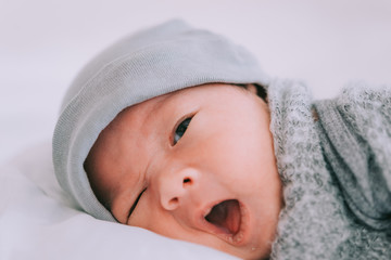 Fototapeta na wymiar Smiling baby boy lying on a white bed, Family morning at home,Children hygiene.