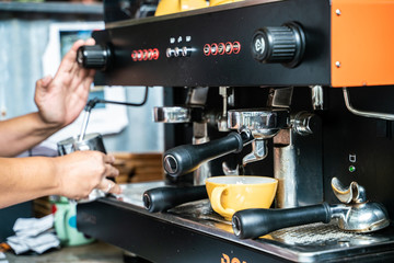 Man hand make coffee by espresso machine hot pouring