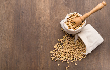 Scattered Soybeans by rustic background from bags
