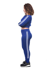 side view of a woman in white background, arms crossed