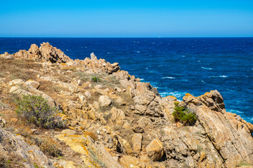 Fototapeta na wymiar Panoramic view of Capo Figari cape rocks and seashore of Spiaggia di Cala Spada beach at the Tyrrhenian Sea coast in Golfo Aranci, Sardinia, Italy