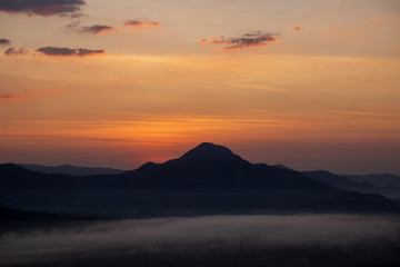 The sunrise with mountains and clouds