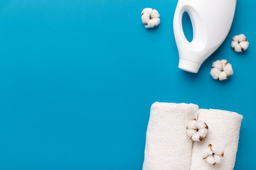 White plastic washing conditioner, cotton towel and cotton flowers