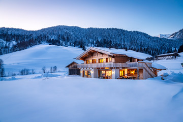Wooden chalet in the alps on a cold winter evening