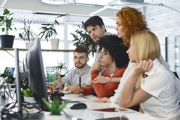 Fatigued group of young employees looking for business solution