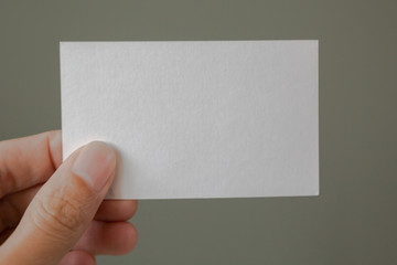 Hand holding blank business card 