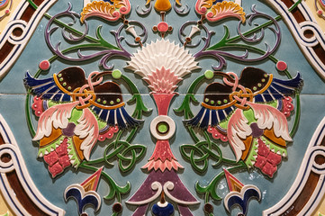Fototapeta premium Ceramics with hand painted traditional patterns. Detail of the traditional tiles azulejos from facade of old house in Lisbon, Portugal