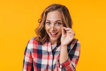 Image of young beautiful woman wearing eyeglasses and plaid shirt smiling