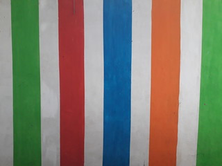 Various colorful vertical lines on the white wall. Great for background, wallpaper and more.