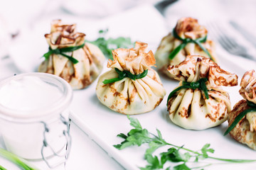 Pancakes with mushroom filling with sour cream