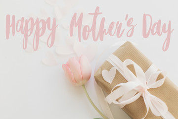 Happy mother's day.  Happy mother's day text and pink tulips with gift box on white background....