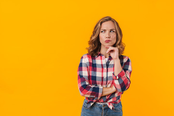 Image of young beautiful woman wearing plaid shirt expressing concern