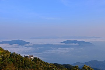The gorgeous view of the fog moves along the mountains in the mountain range with big house on the mountain as foreground at Ba Na Hills, Da Nang, VIETNAM.