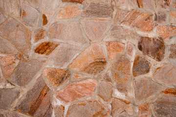 The wall consists of cobblestones. The texture of the stone masonry. Structure.