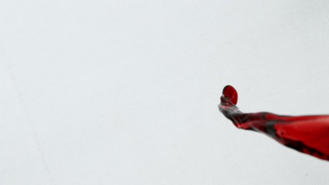 Super Slow Motion Top Shot of Splashing Red Wine on White Cloth at 1000fps.