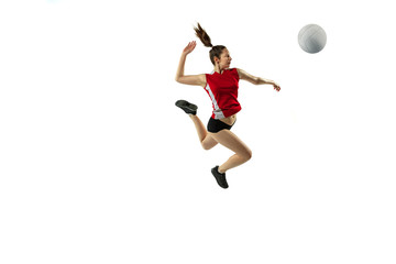 In jump and flight. Young female volleyball player isolated on white studio background. Woman in sportswear and sneakers training, playing. Concept of sport, healthy lifestyle, motion and movement.