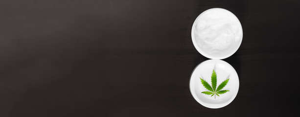 Cannabis CBD balm natural product, cosmetic cream from natural hemp, moisturizing lotion with CBD...