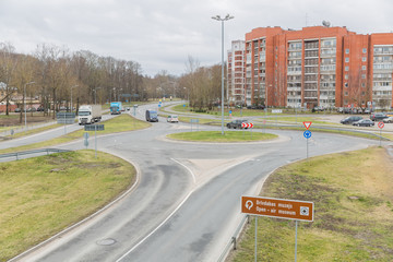 City Riga, Latvia. Cars move on the road. Roundabout in front.