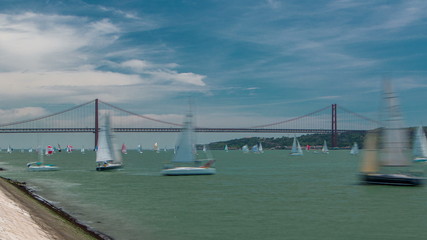 Sailfishes on the Tagus river with 25th of April Suspension Bridge on background timelapse