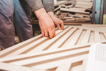 Carpenter measures plywood boards