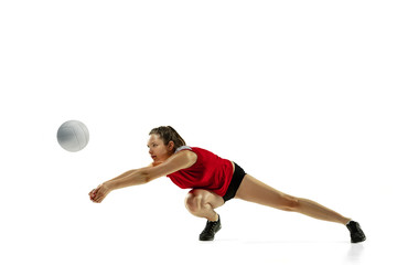 In jump and flight. Young female volleyball player isolated on white studio background. Woman in sportswear and sneakers training, playing. Concept of sport, healthy lifestyle, motion and movement.