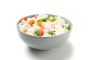 Bowl of delicious rice with vegetables isolated on white background