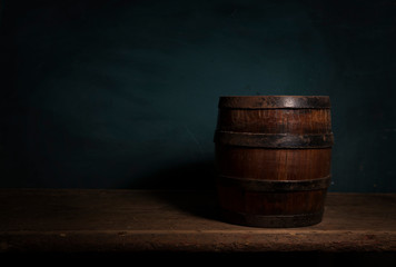 Fototapeta premium Wooden barrel on a table and textured background
