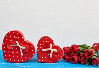 bouquet of red blooming tulips with green leaves