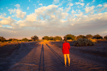 a woman or the sunset in the desert
