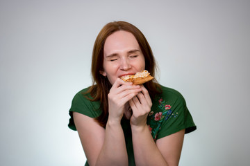 Woman with food in their mouth eating pizza, laugh