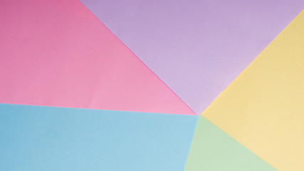 background of blue, yellow, pink, lilac sheets of paper