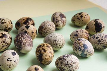 heap of quail eggs on color background. Vegetarian organic  eco food.