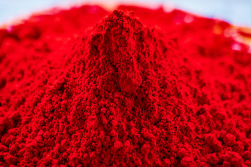 Organic Red Gulal Color. Red organic bright color piled up for Indian Holi Festival. Closeup...