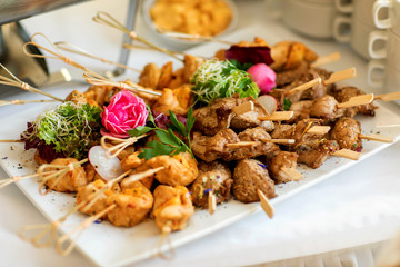 Grilled chicken on bamboo skewers, close up view, shallow depth of field