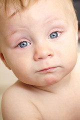 Funny Stare and Face of a Cute 8 Month Old Baby with Blue Eyes