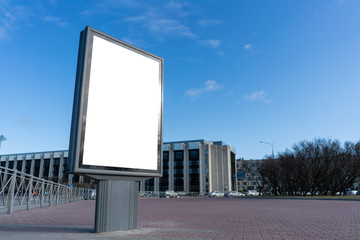 Obraz premium Vertical billboard Advertising canvas mockup on a city square on a sunny good day. With white space for mock-up posters