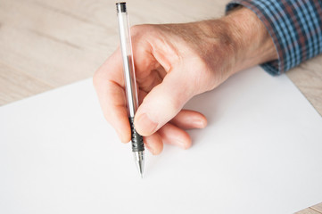 Elderly male right hand ready to start writing.