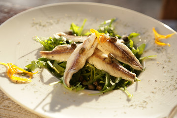 Fish fillet with greens and capers